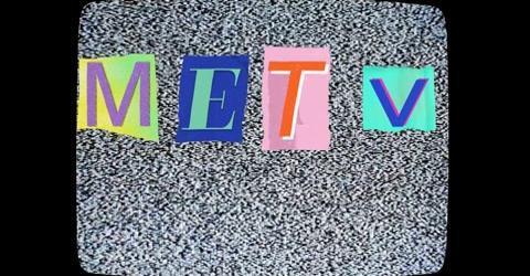 An old-fashioned TV screen of static with METV on it in colorful letters