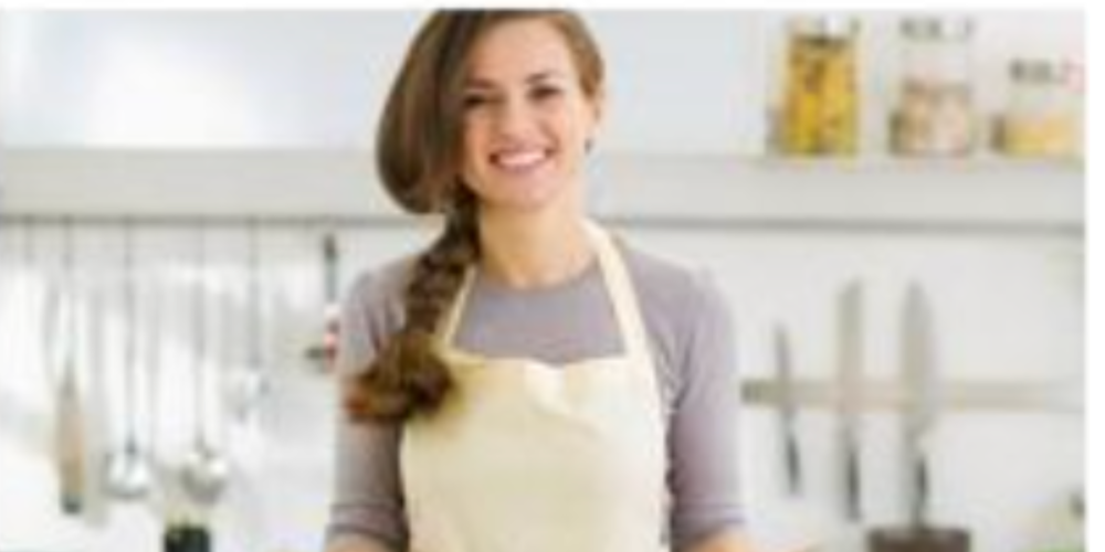a smiling woman in a pristine kitchen